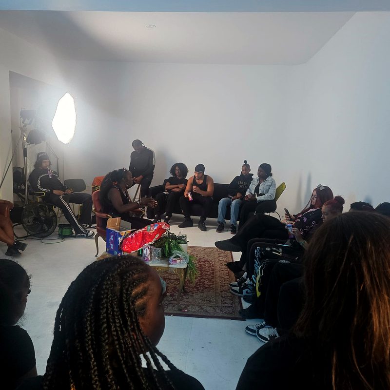 Peaches leading a circle of young people at an Express Yourself session